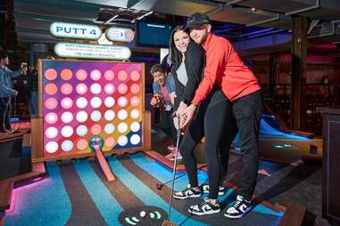 a couple putting at putt shack dallas