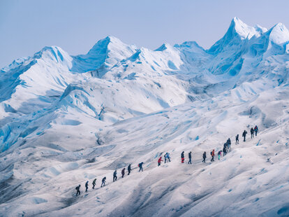 People hiking in a row on the ice of Perito Moreno glacier, Los Glaciares national park, Santa Cruz province, Patagonia Argentina