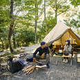 Couple enjoys camping at a campground in the woods.