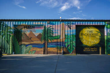 a colorful metal shed painted with images of pyramids