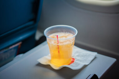 cup of soda on an airplane tray table