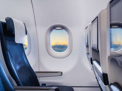Detail of airplane interior with focus on window seat.