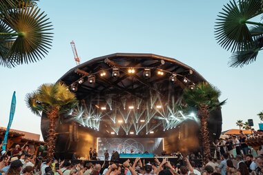 a futuristic, geometric stage at a festival