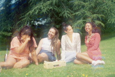Four young women hanging out outside vacation photo