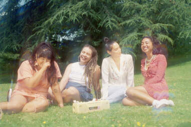 Four young women hanging out outside vacation photo