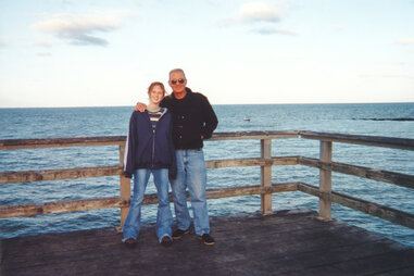 Father and daughter on family vacation pose for a photo