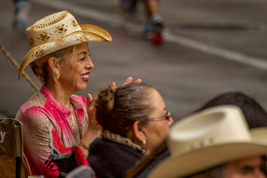 A woman cheering at a rodeo