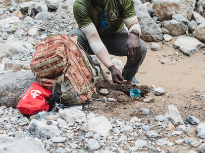 man practicing survival skills in the wilderness on an adventure vacation