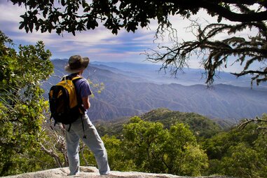 overseas adventure travel by a man in baja who is looking down a mountain