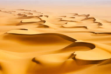 Sand dunes in the Sahara desert at sunrise in Egypt. 