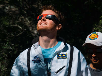 A spectator wears eye protection to view the eclipse in Texas