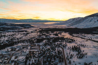 sunset over mammoth lakes and village covered in snow