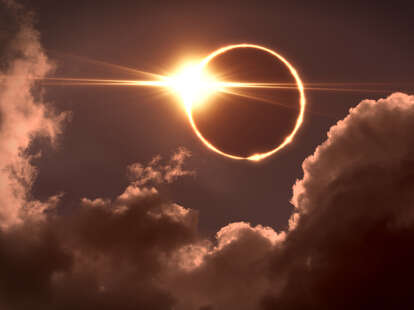 Total eclipse of the Sun, the moon covers the sun in a solar eclipse as seen through clouds