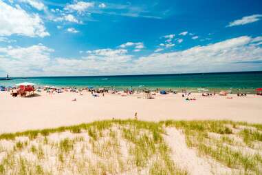 people enjoying the beach and dunes in michigan city, indiana