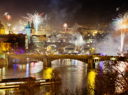 New Years Eve in Prague at night with the view on Charles Bridge and historic center.