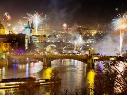 New Years Eve in Prague at night with the view on Charles Bridge and historic center.