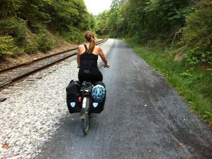 woman in washington biking on a trail accessed by bus without car