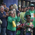 The crowd cheers as participants perform in the annual St. Patrick's Day Parade on Market Street in San Francisco, California.