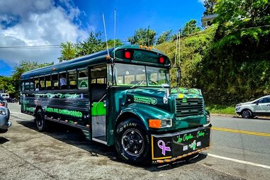 green party bus on the road in puerto rico