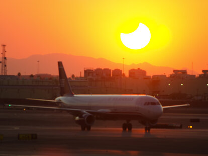 plane with eclipse background