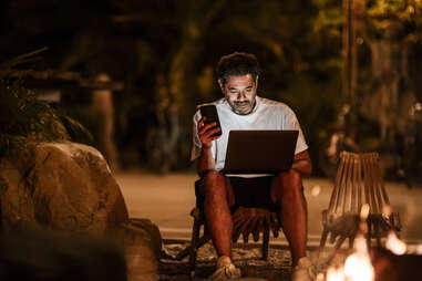 digital nomad using laptop at night