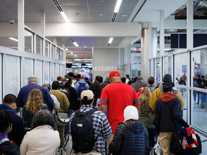 Travelers stand in line for security screening at Hartsfield-Jackson Atlanta International Airport (ATL) in Atlanta, Georgia, US. 