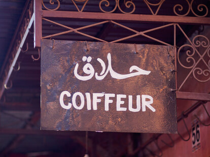 Hairdresser sign in Medina of Marrakech vacation haircut