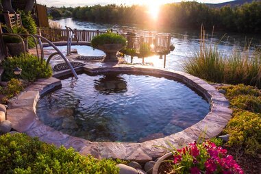 a natural hot spring next to a river