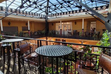 the interior of a restaurant with a glass roof