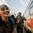 Photo of young women waiting for train together on a train station.