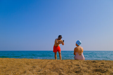 A man taking a picture of his girlfriend.