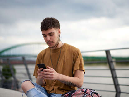 Portrait of young gay man with mobile phone