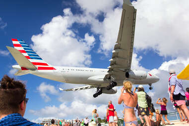 People close enough to almost touch the underside of planes at Maho Beach, PHILIPSBURG, SINT MAARTEN