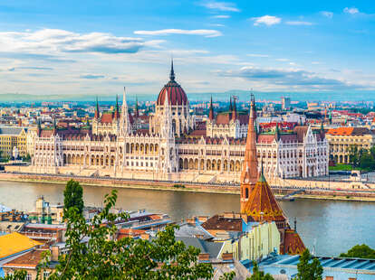 Hungarian Parliament on Danube river in Budapest at sunset during the summer. 
