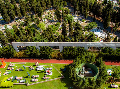 sunbathing locals in istanbul turkey in apartment complex next to cemetery