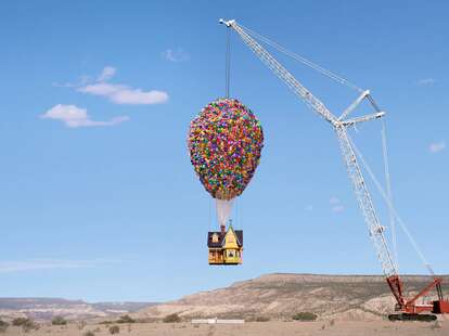 The Airbnb Up House, which is being suspended in the air by a crane. The house even features the balloons.