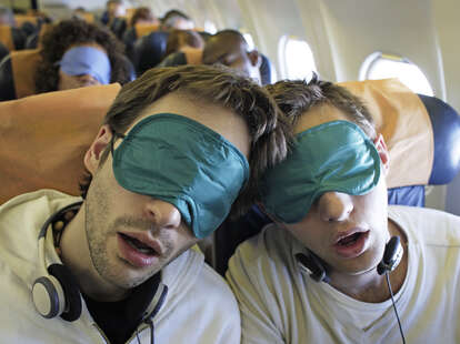 Two men who look a little bit like Josh O'Conner and Mike Faist in Challengers, sleeping on an airplane. 