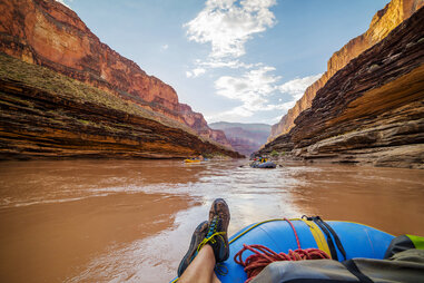 Point of view: feet propped up on a raft floating in the Grand Canyon