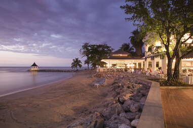 Sunset Beach, Cedar Bar and jetty with pavillion at Half Moon Resort at dusk, Rose Hall, near Montego Bay, Saint James, Jamaica