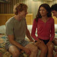 A film still of Mike Faist, Zendaya, and Josh O'Connor (left to right) sitting on a hotel room bed in the movie Challengers. 