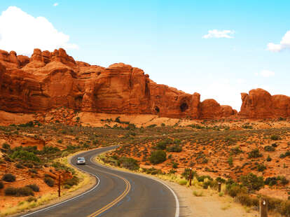 a car driving through arches national park, utah