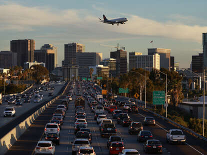 traffic on way to the airport with plane overhead