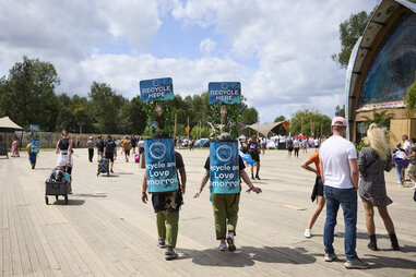 Volunteers collect recyclable waste at the Tomorrowland electronic dance music festival at De Schorre provincial recreational park in Boom, Belgium, on Sunday, July 30, 2023.