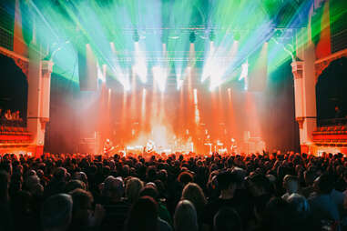 the olympia liverpool crowd wathing band bathed in green and red light