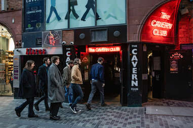 red rum club band entering cavern club front door in liverpool