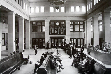 a vintage photo of a waiting area in a train station