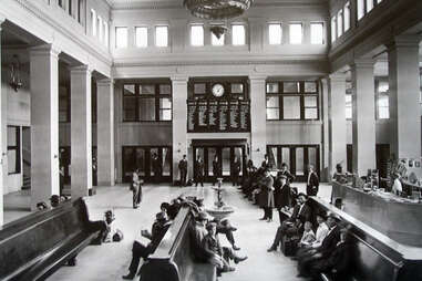 a vintage photo of a waiting area in a train station 