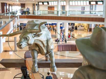 Dallas, Texas, US - 10.2022 - Statue of a cowboy running cattle