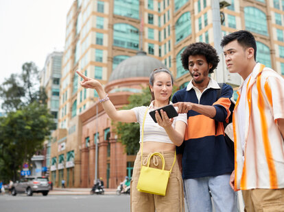 Friends lost in city using map on smartphone when searching for destination