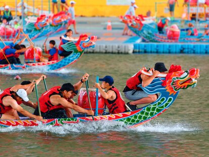 Taiepei, Taiwan, 03, June, 2022: A competitive boat racing tournament in the Dragon Boat Festival on Keelung River, where athletes pull powerfully on the oars and compete vigorously in colorful boats
